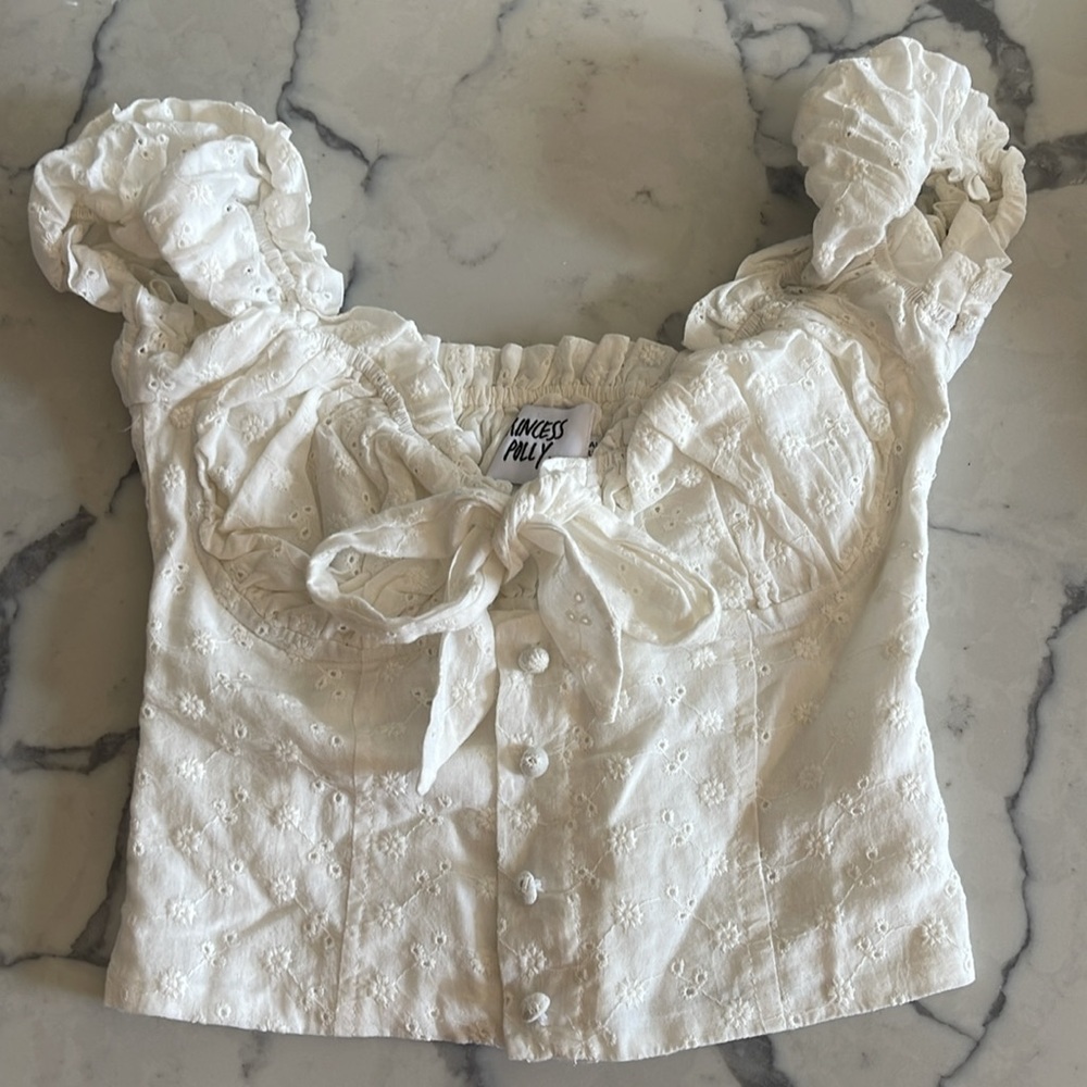 a princess polly white corset top that has flower designs on it